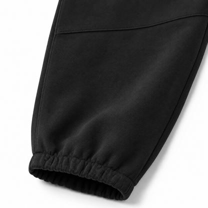 Close-up of the elastic cuff and knee seam detail on the black kids jogger pants.