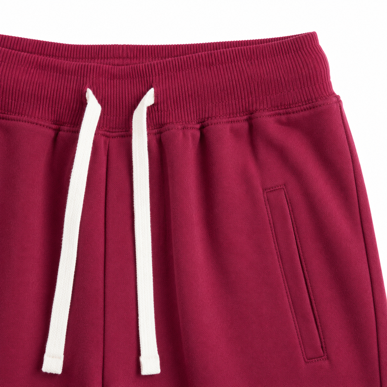 Close-up of the elastic waistband and contrast drawstring on the burgundy kids jogger pants.