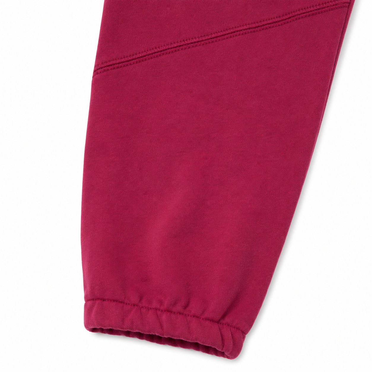 Close-up of the elastic cuff and knee seam detail on the burgundy kids jogger pants.