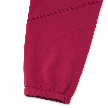 Close-up of the elastic cuff and knee seam detail on the burgundy kids jogger pants.