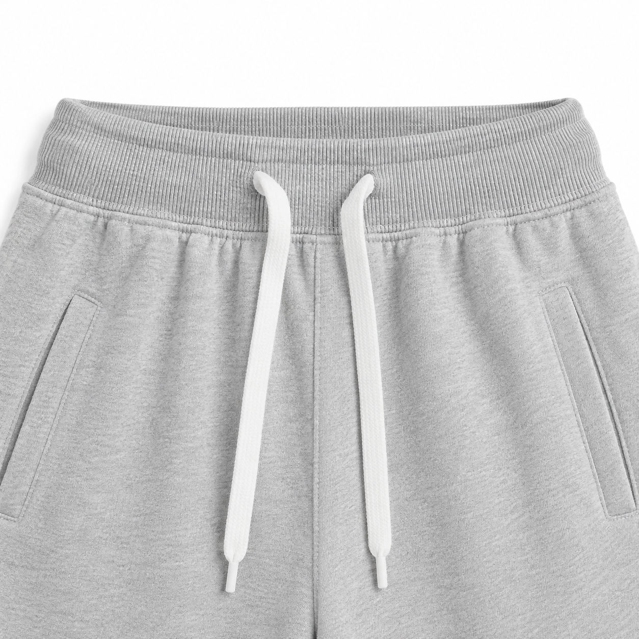 Close-up of the elastic waistband and contrast drawstring on the light gray kids jogger pants.