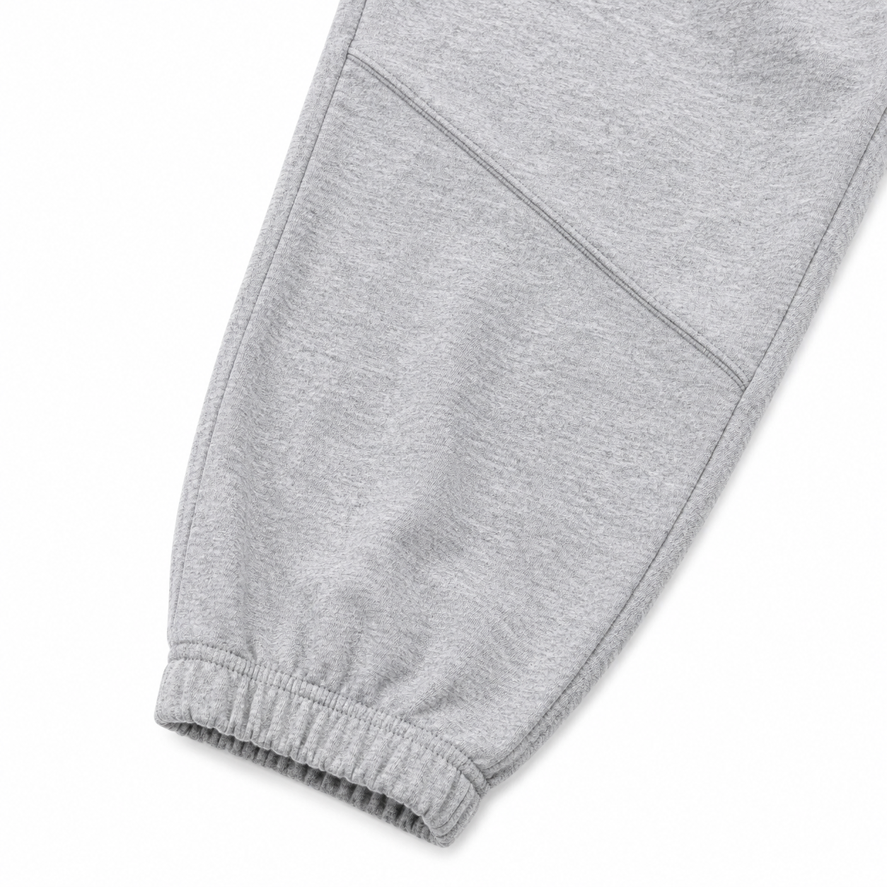 Close-up of the elastic cuff and knee seam detail on the light gray kids jogger pants.