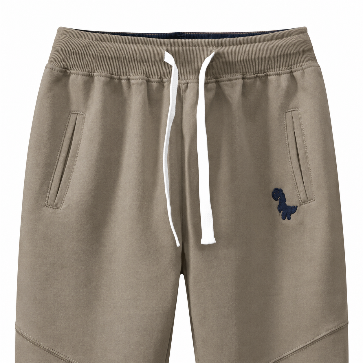 Close-up of the waistband, drawstring, pockets, and knee seam detail on the taupe kids joggers.