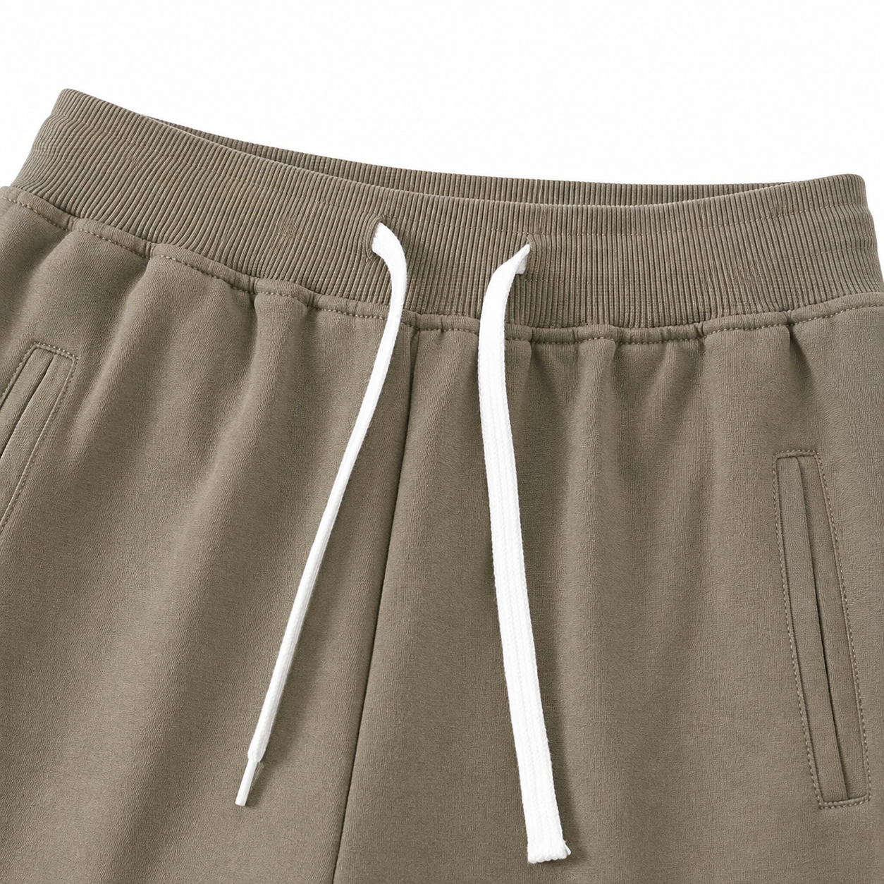 Close-up of the elastic waistband and contrast drawstring on the taupe kids jogger pants.