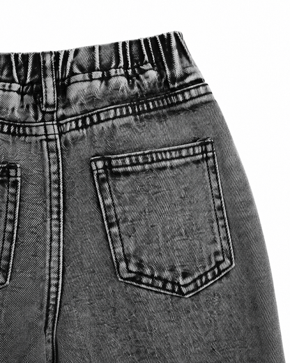 Close-up of the wide-leg denim shape and side pocket detail on the washed black jeans.