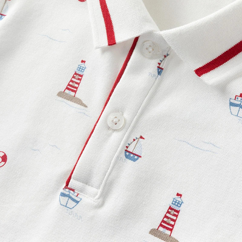 Close-up of the front button placket and nautical print on the boys polo shirt.