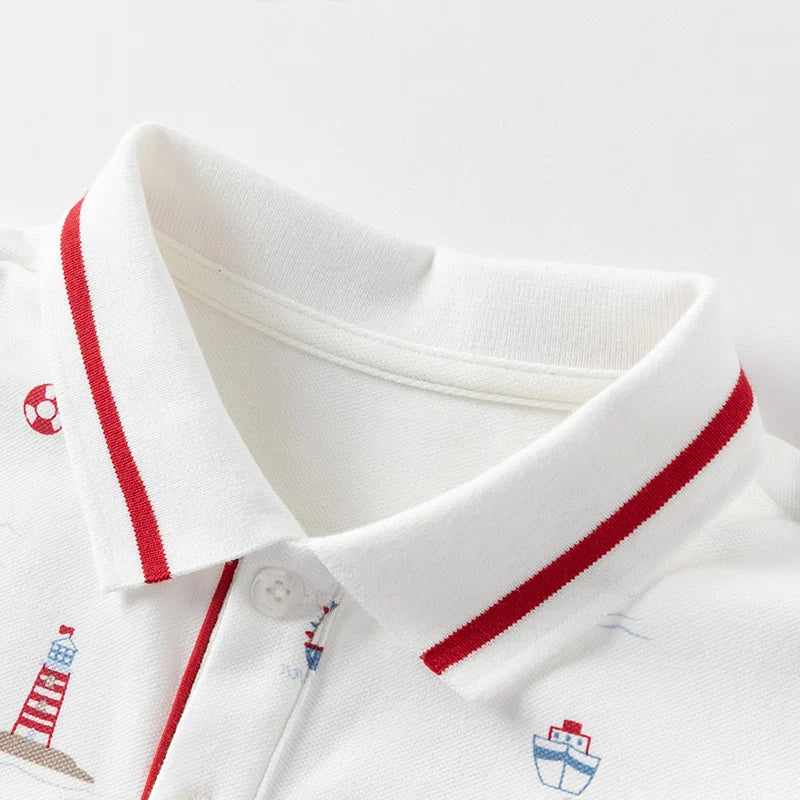 Close-up of the red and navy striped collar on the white boys nautical polo shirt.