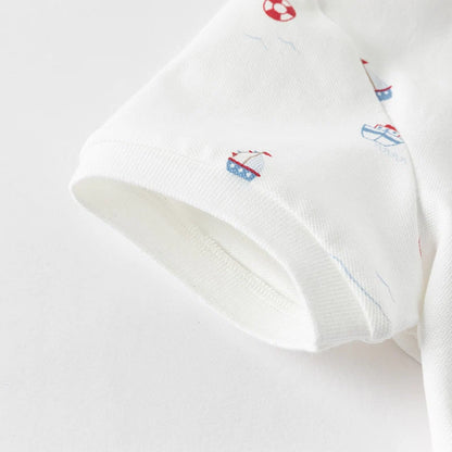 Close-up of the short sleeve cuff on the white nautical boys polo shirt.