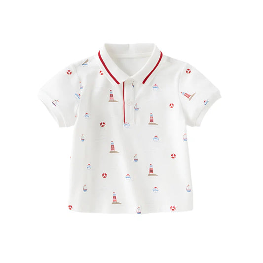 Front view of a white nautical boys polo shirt with lighthouse, sailboat and life ring prints.