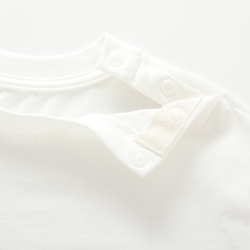 Close-up of the open shoulder snap closure on the white nautical kids T-shirt.