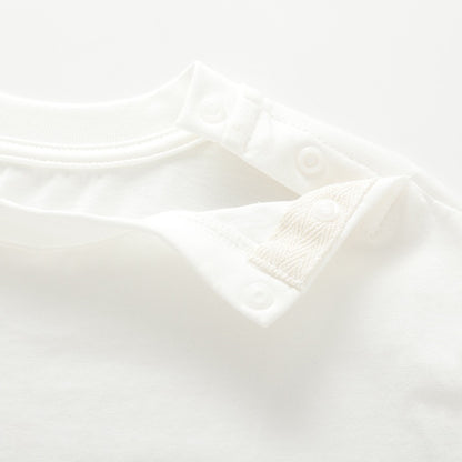 Close-up of the open shoulder snap closure on the white nautical kids T-shirt.