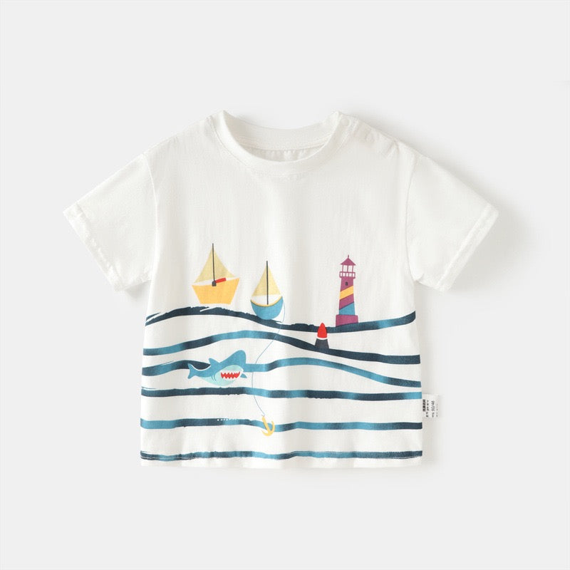 Front view of a white nautical kids cotton T-shirt with sailboats, a lighthouse, ocean waves and a shark graphic.