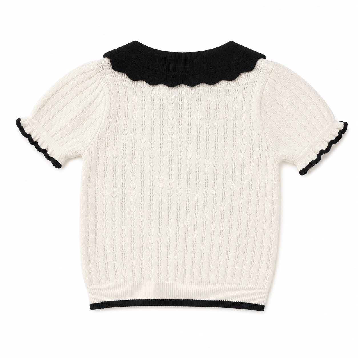 Back view of an ivory girls short sleeve knit top with a black collar and contrast hem.