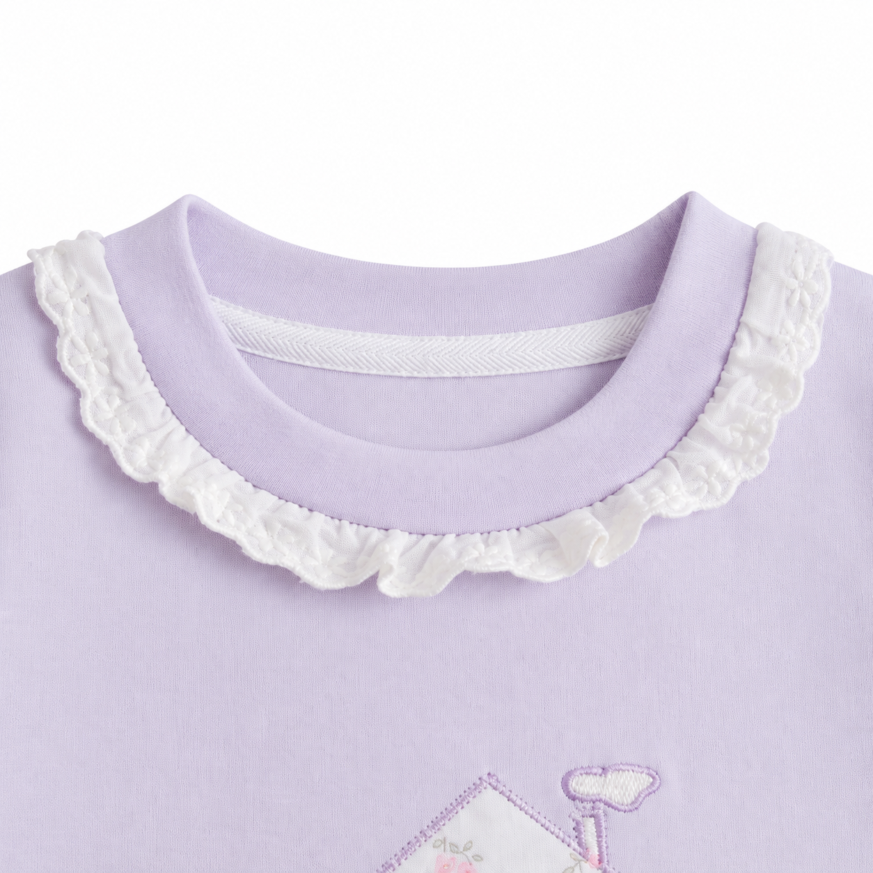 Close-up of the ruffle-trim crew neckline on the Lavender girls cotton long sleeve top.