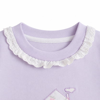 Close-up of the ruffle-trim crew neckline on the Lavender girls cotton long sleeve top.