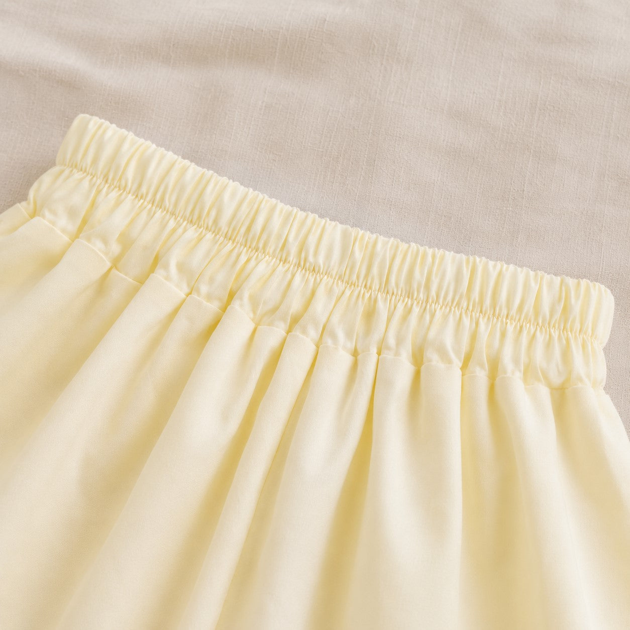 Close-up of the Lila Bloom Set yellow bloomer shorts with an elastic waist.