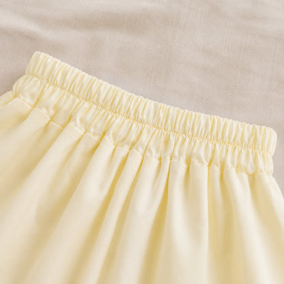 Close-up of the Lila Bloom Set yellow bloomer shorts with an elastic waist.