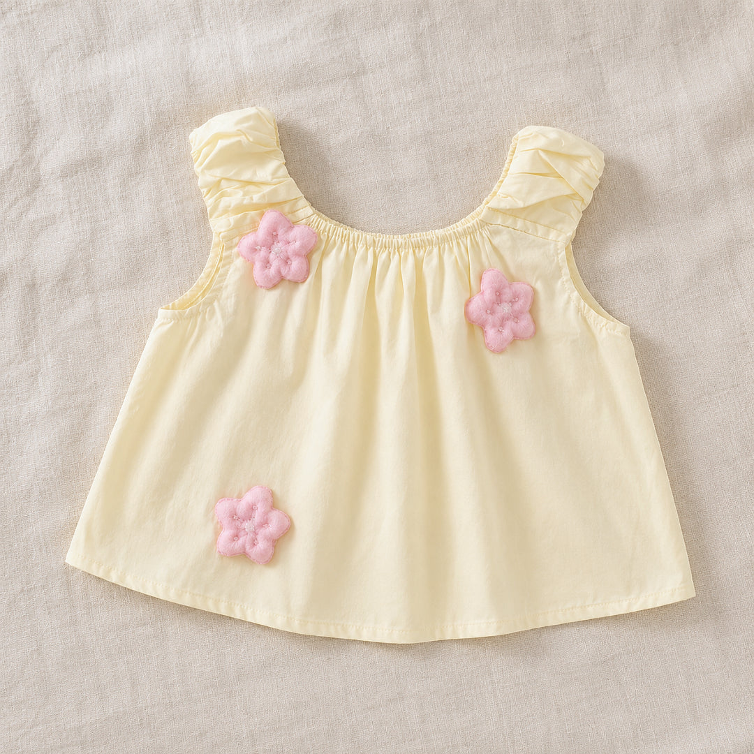 Front view of the Lila Bloom Set yellow sleeveless top with pink flower appliques.
