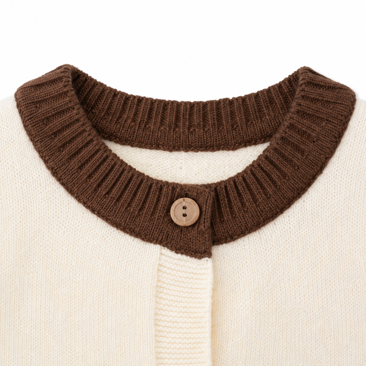 Close-up of the ribbed round neckline and button-front detail on the ivory brown kids knit vest.