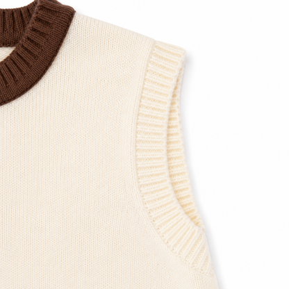 Close-up of the ribbed armhole and knit construction on the ivory brown kids cardigan vest.