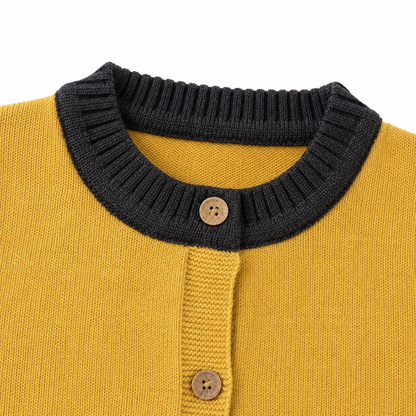 Close-up of the ribbed round neckline and button-front detail on the mustard navy kids knit vest.