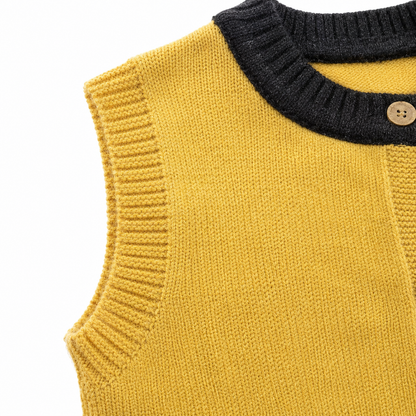 Close-up of the ribbed armhole and knit construction on the mustard navy kids cardigan vest.