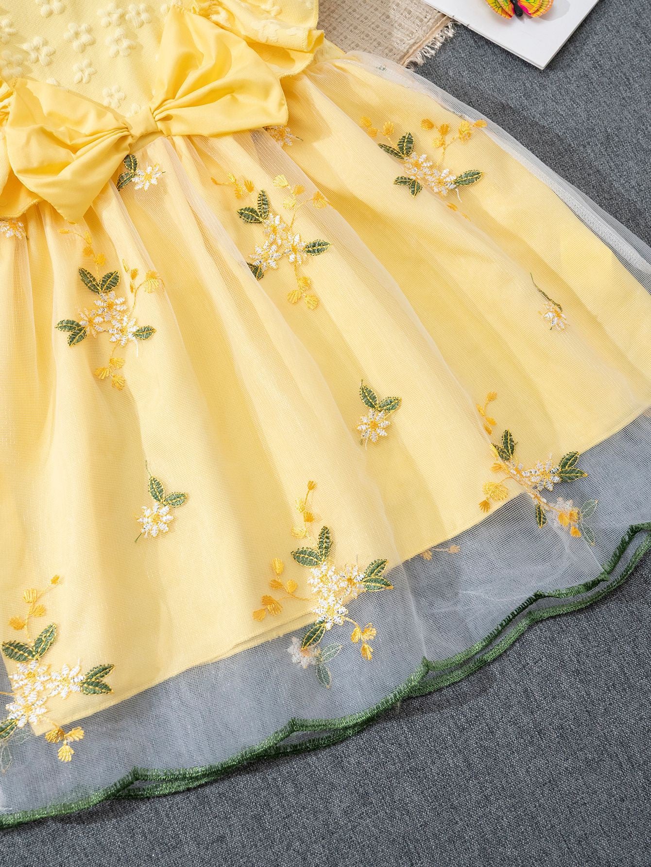 Floral embroidery detail on Lottie Bloom yellow girls tulle dress