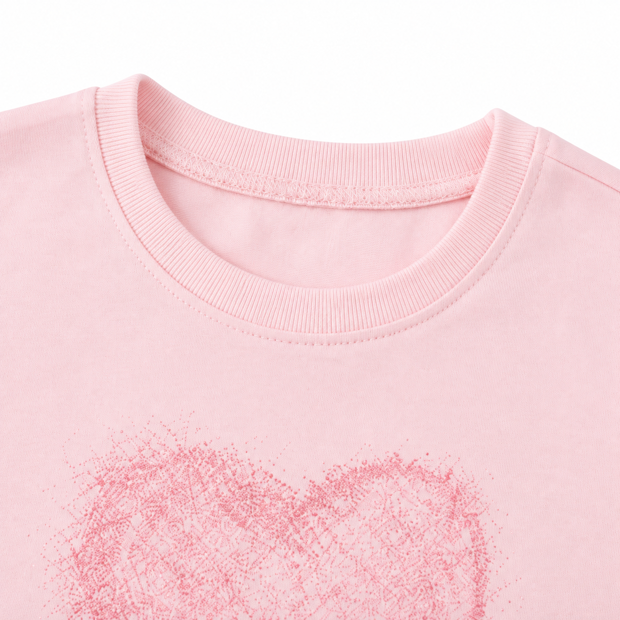 Close-up of the crew neckline on the light pink girls long sleeve tee.