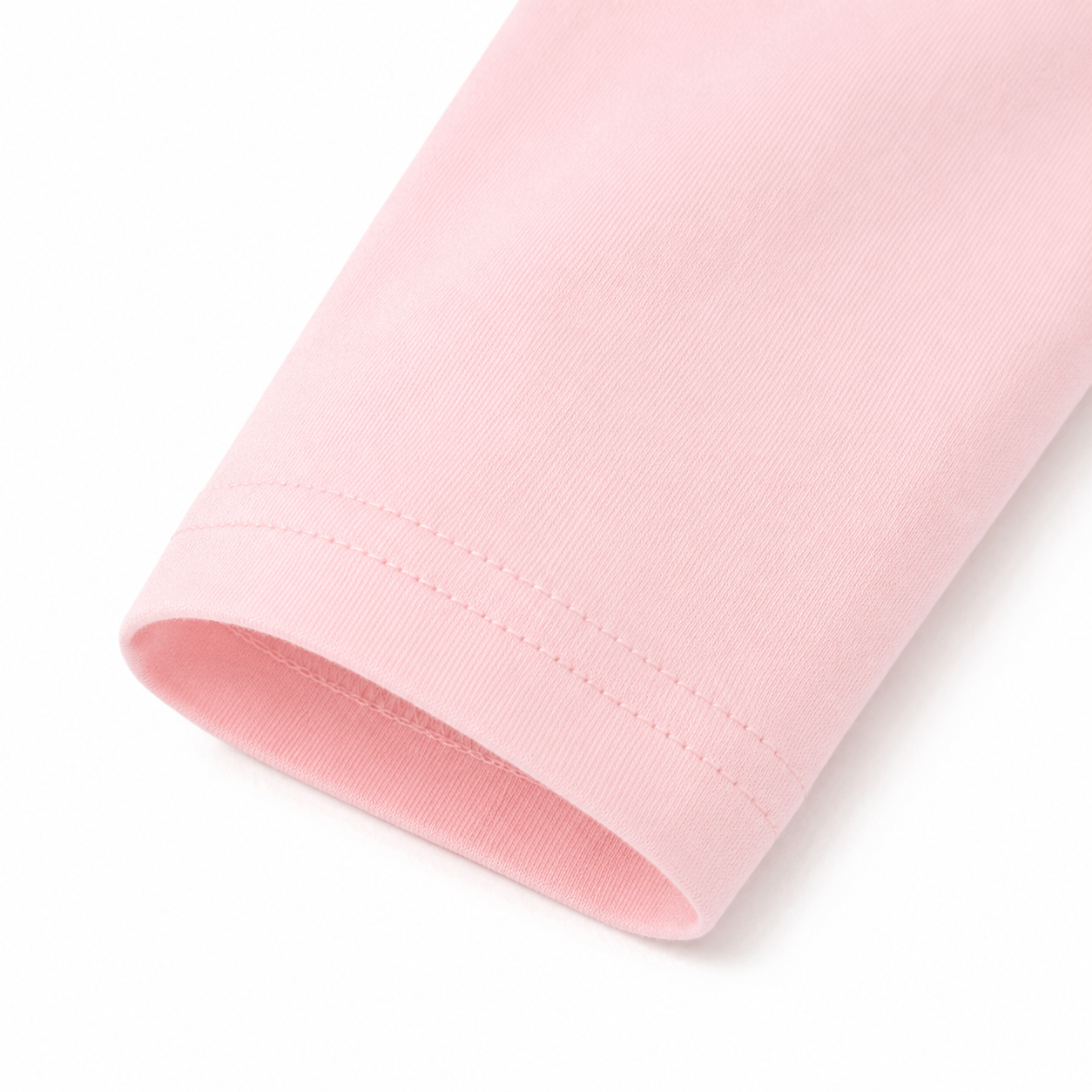 Close-up of the light pink long sleeve cuff and cotton fabric.