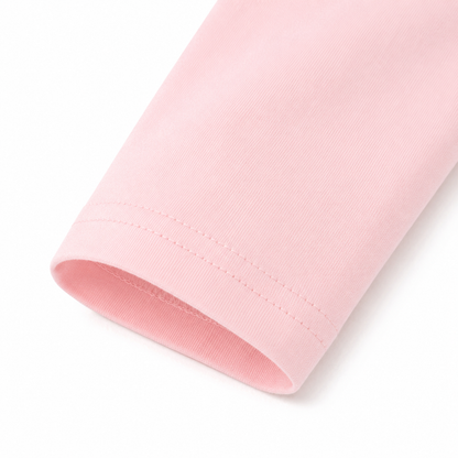 Close-up of the light pink long sleeve cuff and cotton fabric.