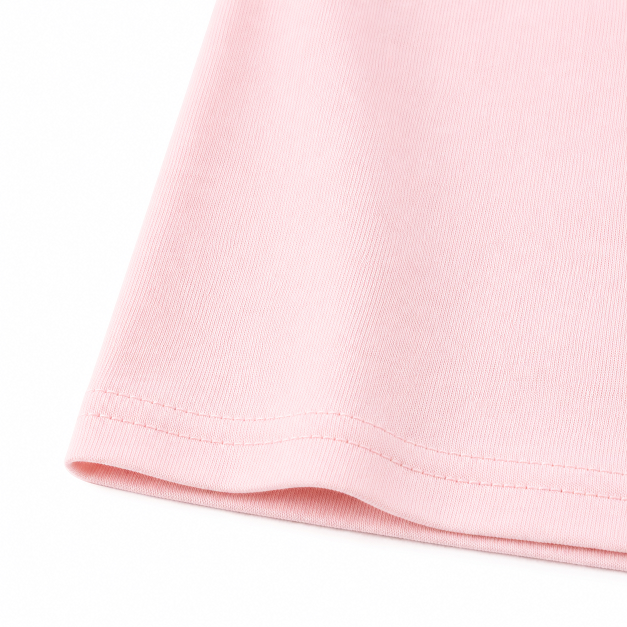 Close-up of the light pink cotton fabric and hem stitching.