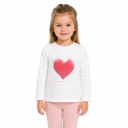 Girl model wearing the white long sleeve tee with a red heart graphic.