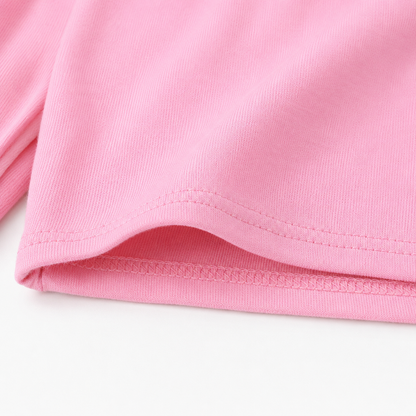 Close-up of the pink shorts hem and fabric detail.