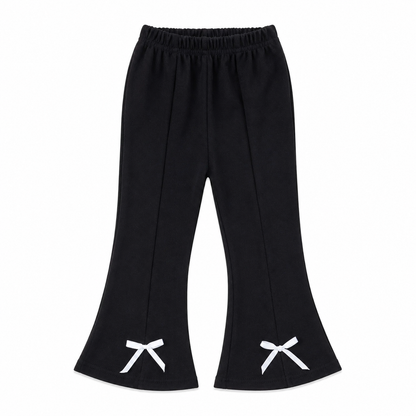 Front flat lay of black girls flare pants with white bow details at the hems.