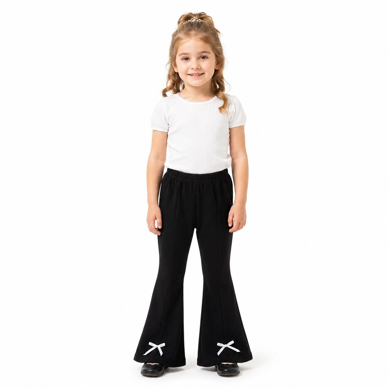Girl model wearing black flare pants with white bow hem details.
