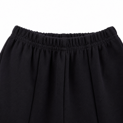 Close-up of the elastic waistband on the black girls pants.