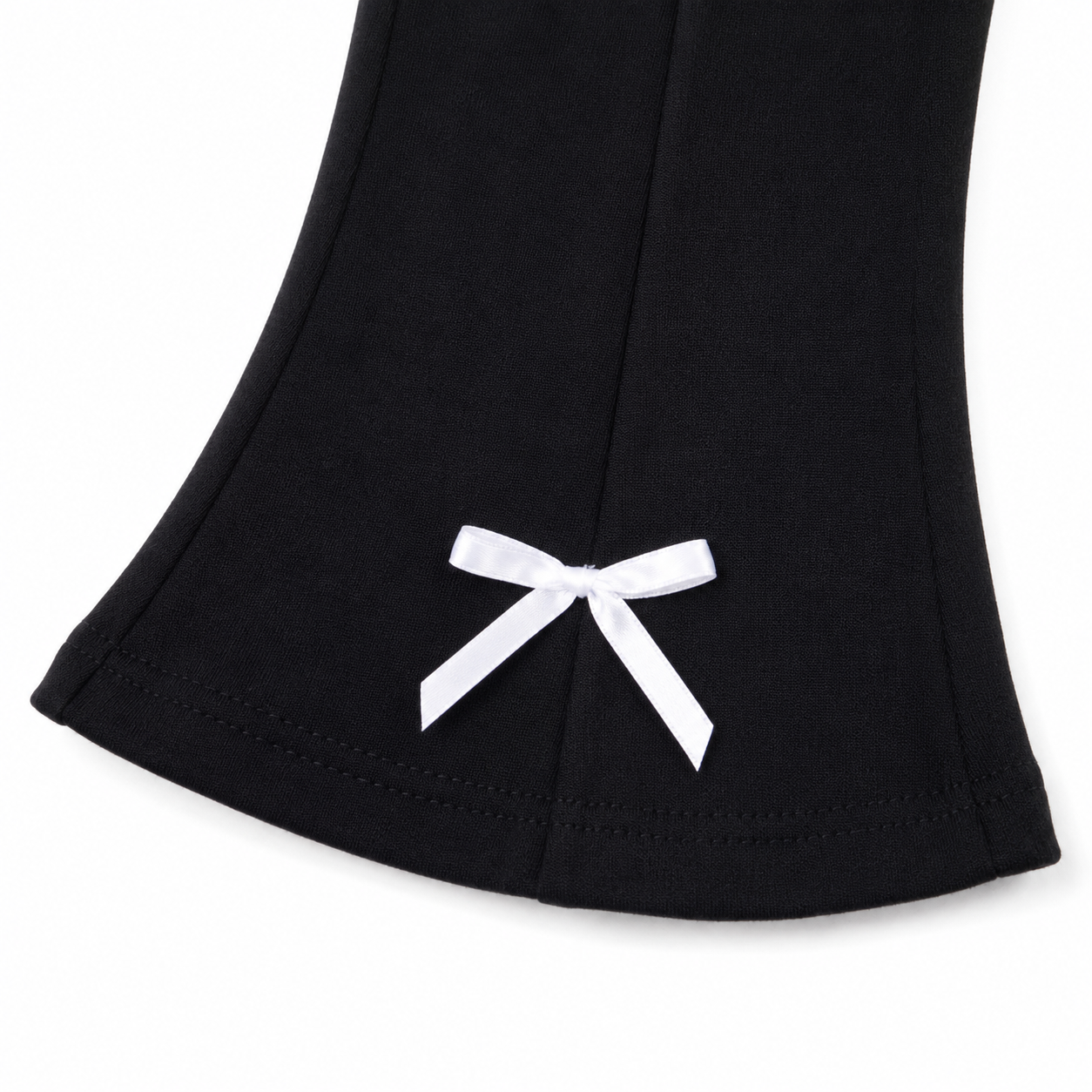 Close-up of the white bow detail at the flared pant hem.