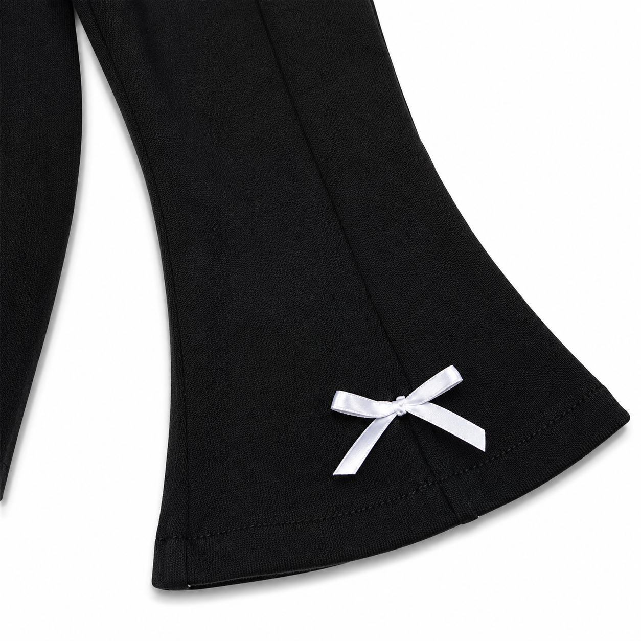 Close-up of the flared leg shape and hem detail on the black girls pants.