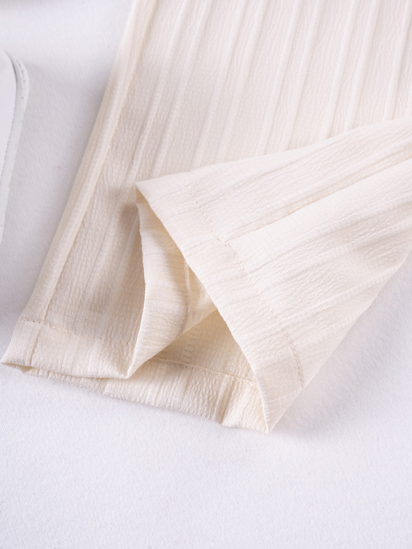 Hem detail on Mila Breeze ivory cream toddler girls wide-leg pants