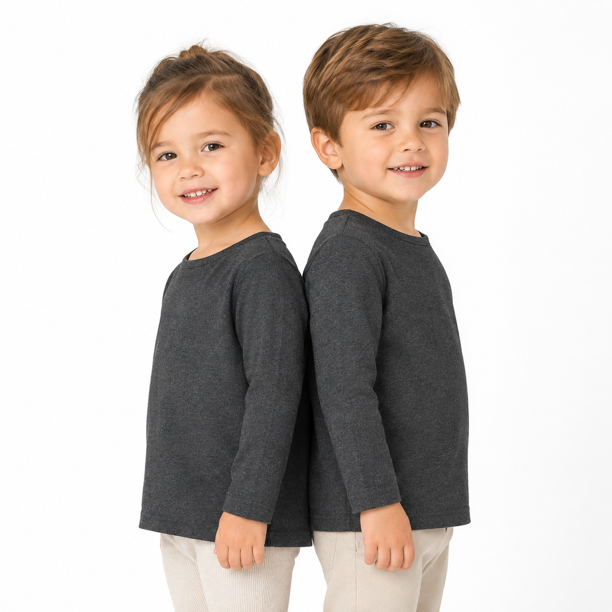 Two child models wearing the charcoal unisex kids long sleeve cotton tee.
