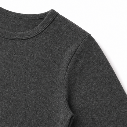 Close-up of the shoulder seam and cotton fabric on the charcoal kids tee.