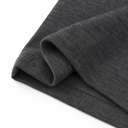 Close-up of the hem stitching and cotton fabric on the charcoal long sleeve kids shirt.