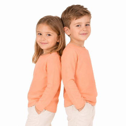 Two child models wearing the peach unisex kids long sleeve cotton tee.