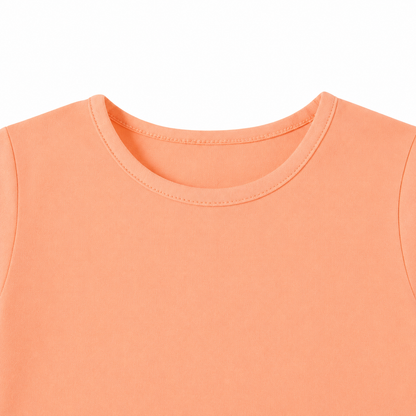 Close-up of the crew neckline on the peach kids long sleeve tee.