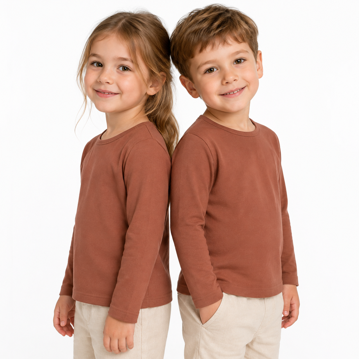 Two child models wearing the terracotta unisex kids long sleeve cotton tee.