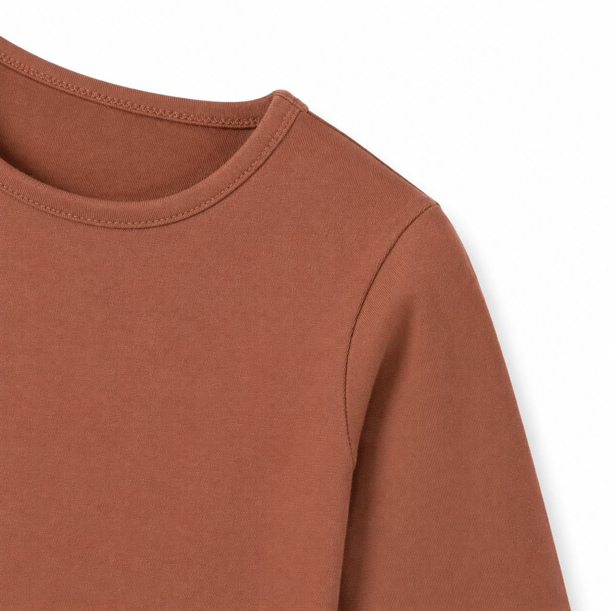Close-up of the sleeve and cuff on the terracotta cotton long sleeve shirt for kids.