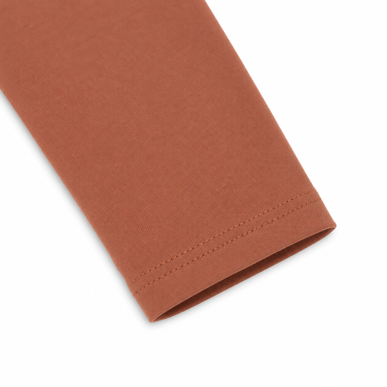 Close-up of the shoulder seam and cotton fabric on the terracotta kids tee.