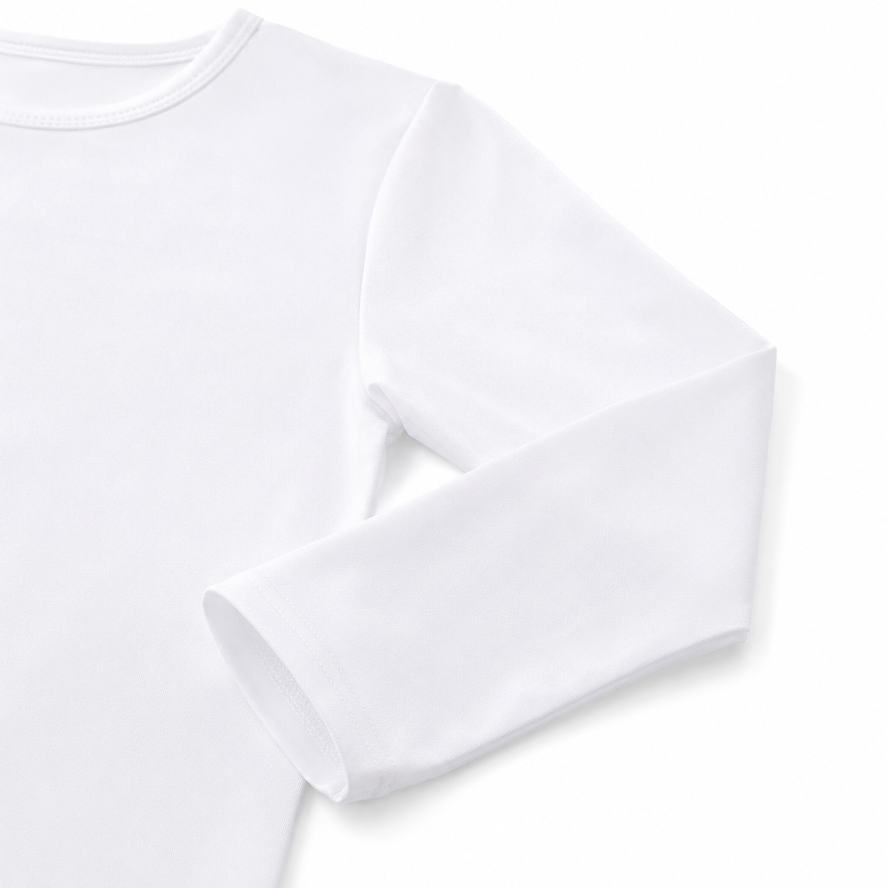 Close-up of the sleeve and cuff on the white cotton long sleeve shirt for kids.