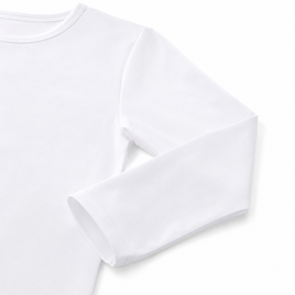 Close-up of the sleeve and cuff on the white cotton long sleeve shirt for kids.