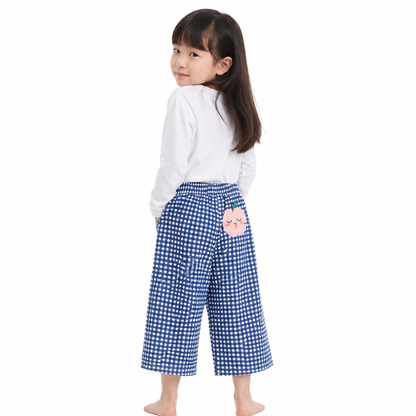 Girl model wearing blue gingham cotton pants with peach patch